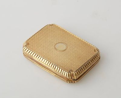 an image of a small gold plated box on a white surface