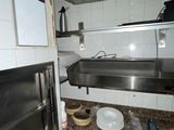 an image of a kitchen with a stove, oven and sink