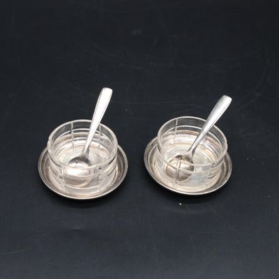 pair of silver plated salt and pepper shakers with spoons