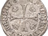 a close up of a coin with a cross on it