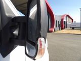 an image of a car ' s side view mirror on the side of the road