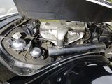 a black car with an engine in the back of it