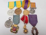 a lot of medals that are on the table