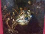 tableau représentant une crèche avec un bébé dans une mangeoire, entouré d'autres personnes