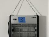 a black and white photo of a hanging fan on a wall