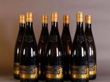 four bottles of wine are lined up on a table