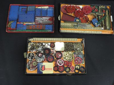 three boxes of assorted items on a black table