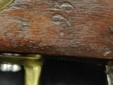 a close up of a wooden gun with a metal handle