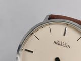a close up of a person holding a wrist watch