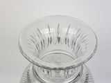 a glass bowl on a plate on a white surface