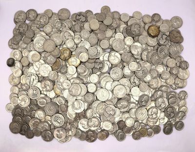 a pile of silver coins sitting on a white surface