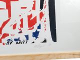 a picture of a red, white, and blue poster on a easel