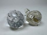 two glass knobs sitting next to each other on a table