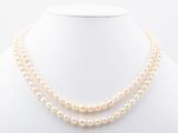 a double strand pearl necklace on a mannequin neck