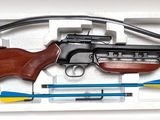 a toy gun in a plastic box with a cord