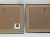 two cardboard boxes with holes in them on a white surface