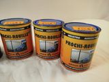 three tins of paint sitting on top of a white sheet