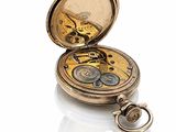 an antique pocket watch on a white surface with a white background