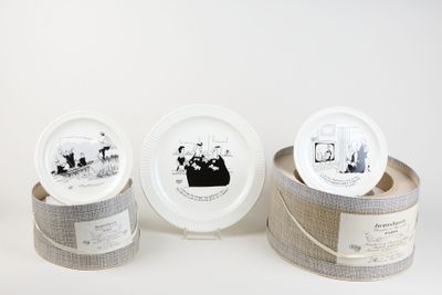 three white plates with pictures of people on them