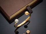 a close up of a box with a bracelet and a pair of earrings
