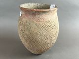 a close up of a vase with a tag on it