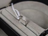 a diamond ring in a ring box on a table
