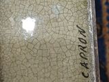 a picture of a cracky glass plate with writing on it