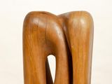 a wooden sculpture of a man and a woman on a pedestal