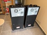 two air conditioners sitting on the floor in a room