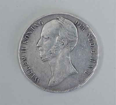 an old silver coin with a man ' s face on it