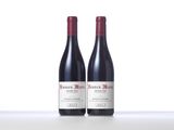 two bottles of wine sitting on top of a white counter