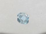 an oval cut aquamarine blue topaz gems on a white surface
