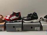 five pairs of shoes are lined up on boxes on a table