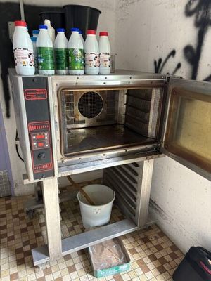 a toaster oven with a lot of bottles of milk on top of it