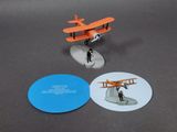 a small toy airplane with a man standing on top of it
