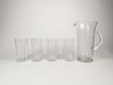 a lot of glasses and a pitcher on the table