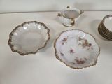 several plates and bowls are arranged on a table