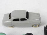 a toy car that is sitting next to a pair of shoes