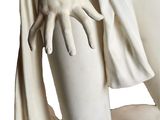statue of a woman with her hands on the back of her body