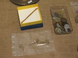 a box of coins and a chain on a table