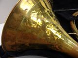 a brass instrument in a black case on a table
