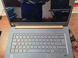 a laptop computer sitting on a table with a cup of coffee
