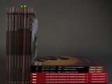several books are stacked on top of each other on a table
