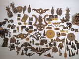 a large collection of antique metal items on a white surface