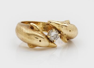 a close up of a gold ring with a diamond in the middle