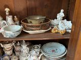 a wooden cabinet with a lot of dishes and bowls on it