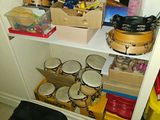 a white shelf with many items on it in a room