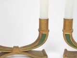 pair of brass candlesticks with green and white candles