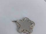 silver plated star of david pendant on a white plate