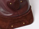 brown leather bag with a zipper on top of it sitting on a white surface